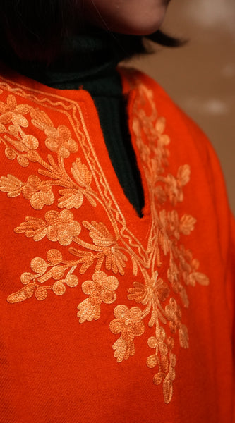 Kids wearing Saffron Kashmiri pheran kurta with traditional embroidery, designed for festive and cultural occasions.