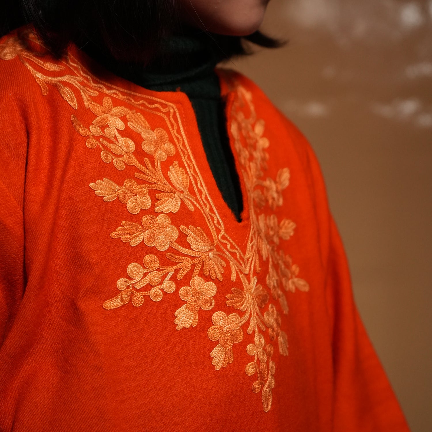 Kids wearing Saffron Kashmiri pheran kurta with traditional embroidery, designed for festive and cultural occasions.