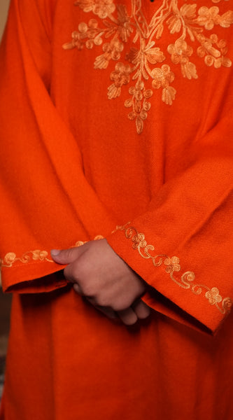 Orange fabric with gold embroidery. Kashmiri Pheran.